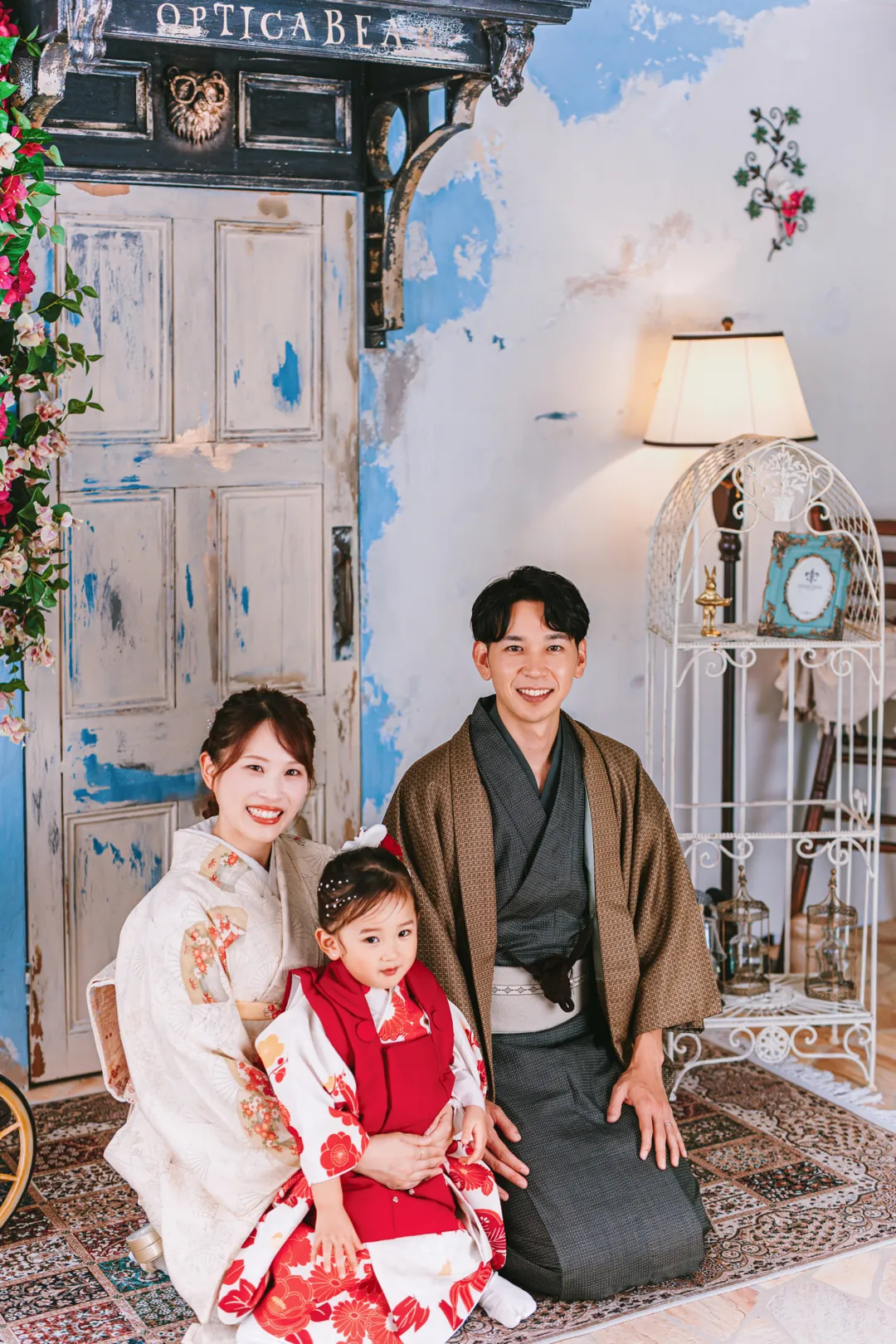 眼鏡屋の前で座る、着物の家族